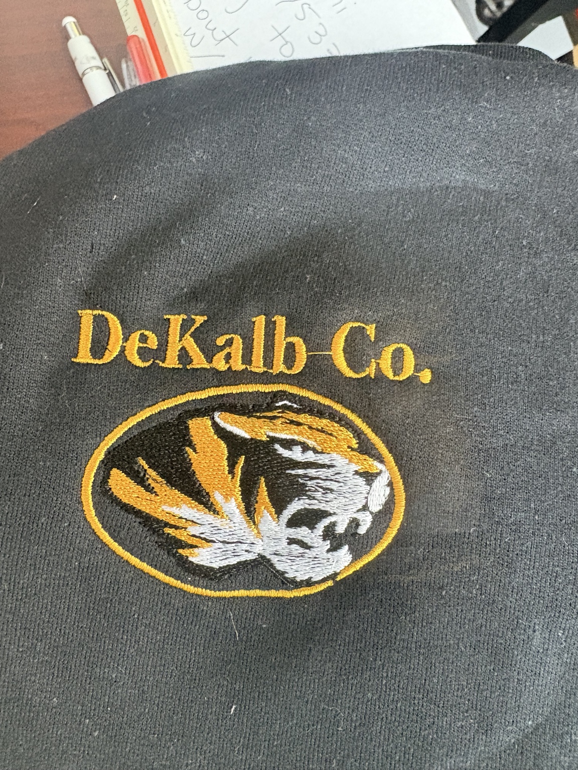DeKalb County logo embroidered on a dark jacket by S&B Design & Graphics